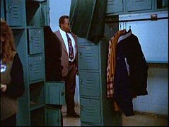 Beyond the sections of lockers is an aisle by the wall.