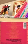 Top: A closeup of the shelf behind Travis Touchdown's recliner, showing the spine and a portion of the back cover of Music from the Motion Picture Wayne's World. Bottom: The back cover and spines of the soundtrack in reality.