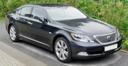 Front quarter view of a sedan parked on a street.