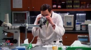 Sheldon looking through the microscope