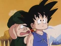Oolong hiding behind goku