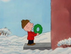Charlie Brown trying to sell a wreath
