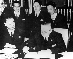 Watched by the Japanese signatory, Japanese ambassador to Nazi Germany Viscount Kintomo Mushakoji, Hitler's foreign affairs adviser Joachim von Ribbentrop signs the Anti-Comintern Pact, November 25, 1936.
