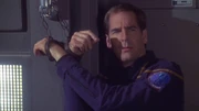 Archer shackled to the wall by the Ferengi.