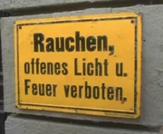 A sign in the German language stating "Smoking, open flame and fire prohibited".