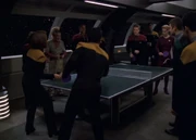 Voyager crew members playing doubles ping pong