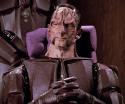 Macet, wearing a beard and early Cardassian uniform
