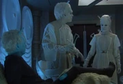 An Aenar female enters as a physician provides Shran with medical aid