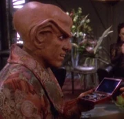 Quark holding a container of Andarian glass beads.