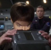 A scope with a buttoned control surface, being used by Vulcan science officer T'Pol in 2151