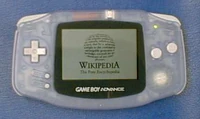 A GBA with the Wikipedia logo on its screen.
