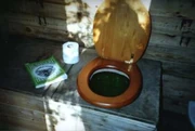 A DIY compost toilet at Dial House, Essex, England, created at very low cost utilising an old school desk as the toilet unit [1]