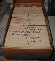 A box of punch cards with several program decks.