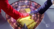 Baby Kal-El being put in a spaceship by his parents.
