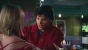 Chloe braces herself as Clark prepares to burn her shoulder.