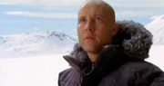 Lex approaches the Fortress in snow gear.