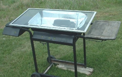 This simple solar oven was made on the recycled lower body of a gas grill.  Roast a chicken, slow cook, reheat food.  Today I cooked two chicken thighs insde the oven.  They were so tender that the bones came apart very easily.  The oven appears to reach temperatures above 200 degrees F.  It will hard boil eggs.