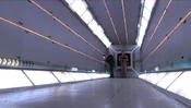 A scientist working in the corridor as a power spike occurs.