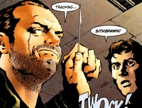 Chik Apla demonstrates his knife-throwing skills to Banner Sumptor.