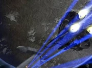 A tri-fighter firing a volley of homing missiles.