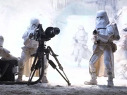 Three snowtroopers on Hoth setting up an E-web heavy repeating blaster.