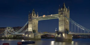 Tower Bridge crosses the River Thames next to the Tower of London.