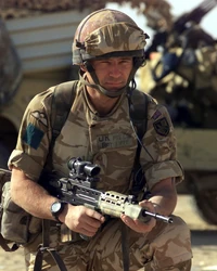 Armed with an L85A2 rifle, a British Army troop from the 3rd Battalion, Parachute Regiment, kneels while demonstrating a vehicle check point system at landing strip Viper, in support of Operation IRAQI FREEDOM.