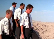 Doggett with members of his task force, looking down at "Mulder"'s fallen body from the edge of a cliff in Arizona.