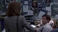 Dana Scully meets Fox Mulder in his FBI office.